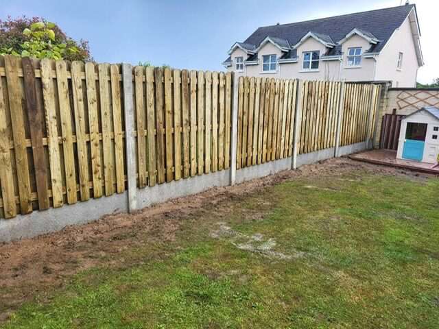 New close-board timber fence with a raised planter bed