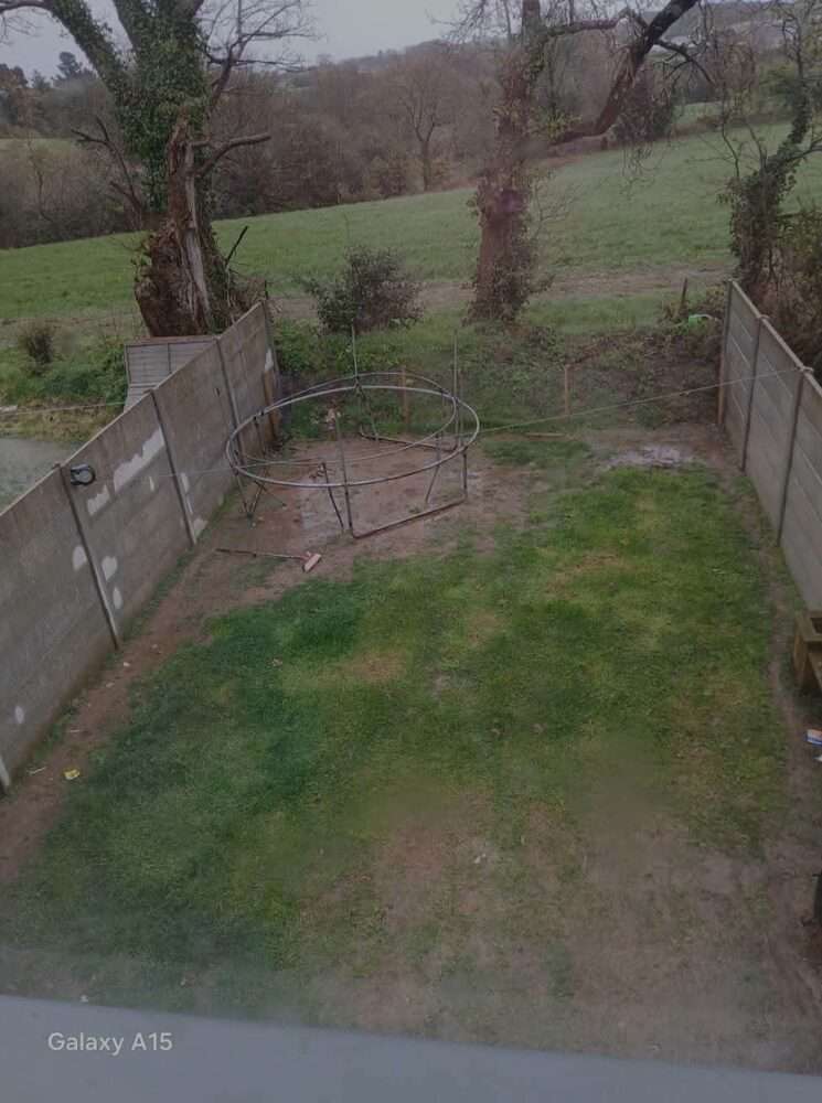 Finished timber boundary fence along a driveway