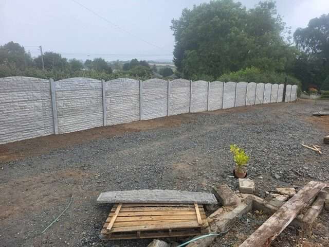 New timber fence around a tidy garden with house behind