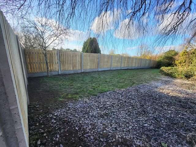Muddy garden with old walls before artificial grass installed