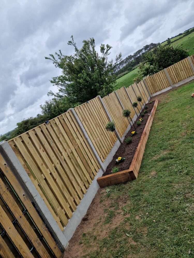 Yard with old concrete wall panels before new fencing